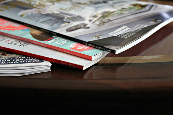 Magazines stacked on table